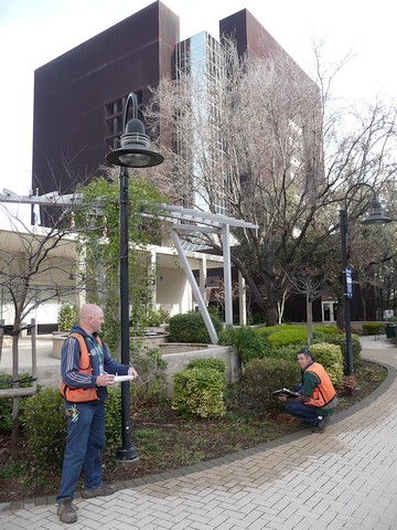 Two men conducting research outside of an office building